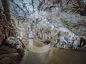 View of stalactites and stalagmites in an underground cavern - Postojna cave in Slovenia