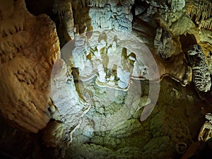 View of stalactites and stalagmites in an underground cavern - Postojna cave in Slovenia