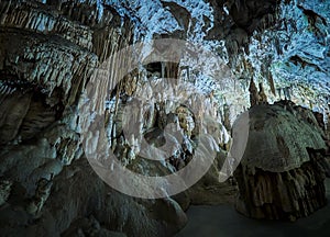 View of stalactites and stalagmites in an underground cavern - Postojna cave in Slovenia