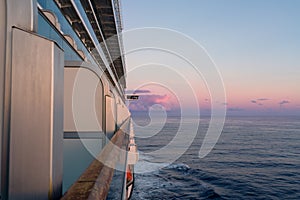 View of the starboard side of a cruise ship at sunset in the Caribbean Sea