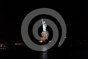 A view of Statue of Liberty at night from a ferry