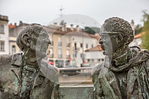 View at the statue of two men seat on bench, artistic personalities on Tomar city photo