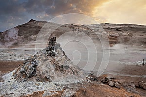 View of steaming fumarole in geothermal area of Hverir at Namafjall at sunset