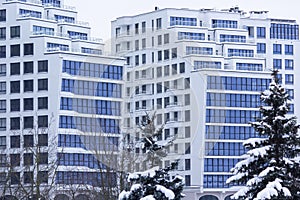 View of the steel blue background of glass high-rise buildings in a modern futuristic city center in winter. Business concept for