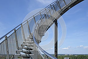 View of a steep upward flight of stairs in front of a blue sky