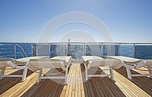 View from stern deck of luxury yacht with sunbeds
