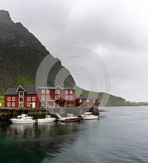 View of the Stockfish Museum in the Lofoten Islands with boats moored at the docks in the foreground