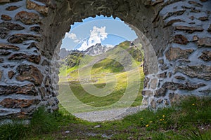 view through stone arch to mountain landscape Parsenn, swiss alps above Davos photo