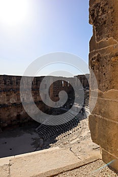 View through the stone arch to well preserved Roman theatre in ancient city Aspendos, Turkey