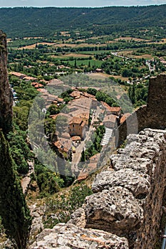 View of stone staircase, roofs and belfry in Moustiers-Sainte-Marie.