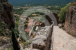 View of stone staircase, roofs and belfry in Moustiers-Sainte-Marie.