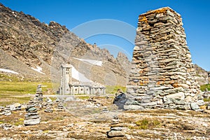 View at Stone tower and Church of Our Lady of All Prudence at Col de l Iseran pass in Savoie Alps - France photo