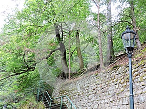 View of stone wall, stairs, lantern and forest in Karlovy Vary, Czech Republic