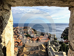 A view through the stone window of the Minceta Tower or Fortress looking out at the old town and walls of Dubrovnik