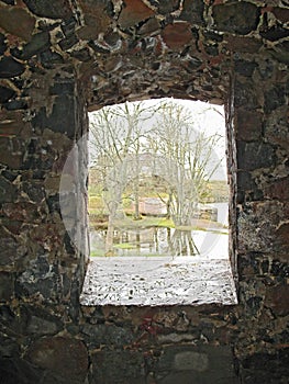 View through stone window in the wall of castle.