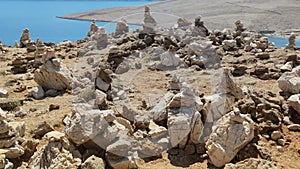 View of Stones stacked on top of each other in small columns on the Croatian island of Pag, Feng shui stones, slow motion