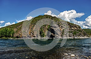 View from the stony shore of the mountain river