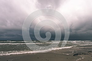 View of a stormy beach in the morning. - vintage film look