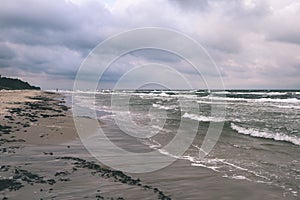 View of a stormy beach in the morning. - vintage film look