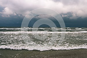 View of a stormy beach in the morning. - vintage film look