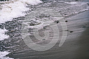 View of a stormy beach in the morning. - vintage film look