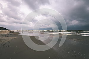 View of a stormy beach in the morning. - vintage film look