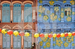 A view of a street in Chinatown district with colorful old buildings and red and yellows lanterns decorations.