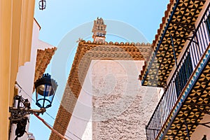 View of the street lamp and spanish tiles at the bottom of balconies in the historic center of Sitges, Barcelona, Catalunya, Spain