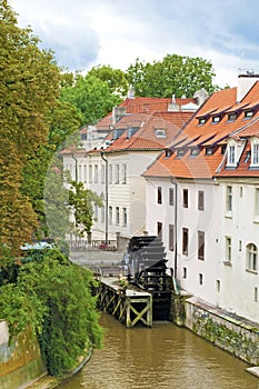 View of the street in the old town with water mill in Prague, Cz
