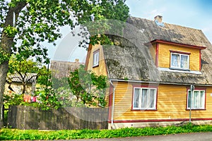 View of street with old wooden house in Parnu, Estonia