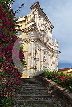 View of the streets and stairs of a small medieval village, at the top of the stairs the local church, next to the stairs a beauti