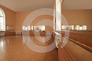 View of studio, focus on ballet barre. Space for text