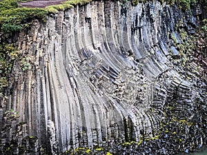 The view of Studlagil basalt colums in canyon