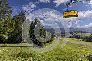 View summer day of chairlift to the mountain from top of the Slotwiny Arena ski station, Krynica Zdroj, Beskid Mountains,