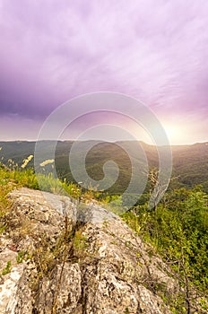 View of sun lazily rising from behind the mountain