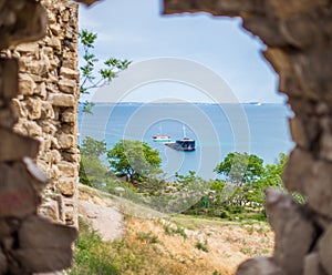 View of the sunken ship through the loophole in the stone wall o