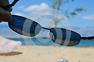 View on sunny beach through dioptric sunglasses with UV 400 filter