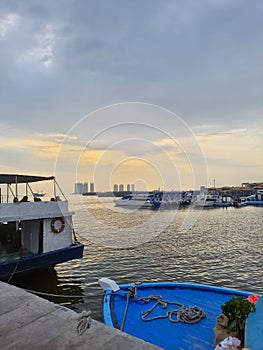 A view of the sunrise over a harbor in Jakarta