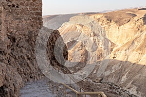 View  during sunrise from the ruins of the fortress wall of the fortress of Masada to the ruins of the palace of King Herod and to