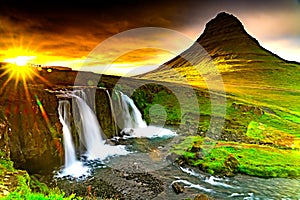 View of sunset at Kirkjufellsfoss waterfalls and Kirkjufell mountain