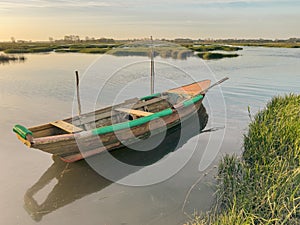 View of sunset on Ria de Aveiro with a typical fishing boat, Ovar, Portugal photo