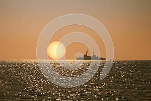 The view of the sunset  on sea with boat by the sea is very disturbing