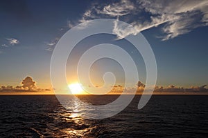 View of the sunset from the ship underway and in the port. Colorful views of the surface of the water and the sky with clouds.