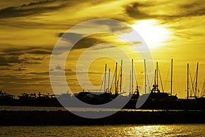 View of sunset and silhouettes of yachts on the lake