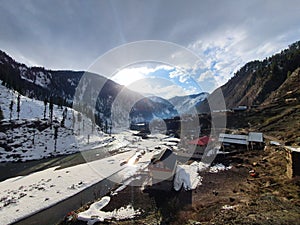 view of sunset in village durring the winters in a mountain valley