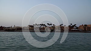 View of the sunset on the water canals of the city. The camera removes from the moving boat.