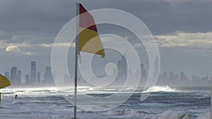 View of Surfer`s Paradise hotels, from between the flags at Palm Beach, Gold Coast, Australia.