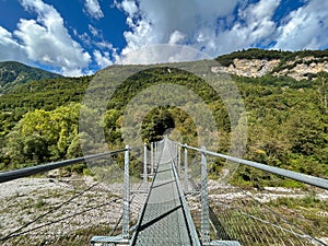 View of suspended tibetan bridge near Tenno lake in Trentino Italy