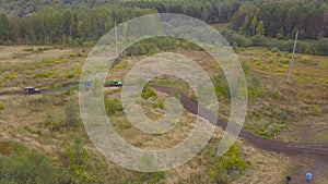 View of SUVs riding on puddle. Clip. Top view of surmounting puddles of SUVs on mud races. Jeep racing photo