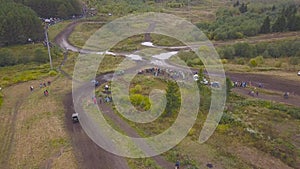 View of SUVs riding on puddle. Clip. Top view of surmounting puddles of SUVs on mud races. Jeep racing photo